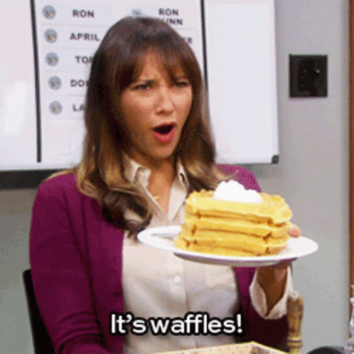 Woman Holding Waffles With Whipped Cream GIF