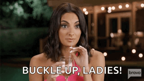 Woman Holding Wine Saying Buckle Up Ladies