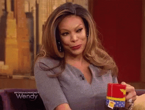 Woman Holding Wonder Woman Cup With Funny Face GIF