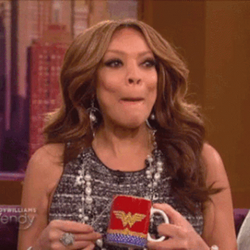 Woman Holding Wonder Woman Mug Making Face GIF