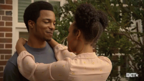 Woman Hugging Man at Brick Building With BET Logo