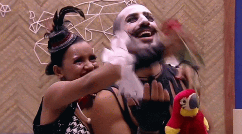 Woman Hugging Masked Man And Holding Stuffed Parrot GIF