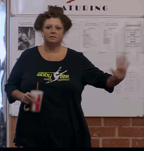 Woman in Abby Lee Dance Shirt by Whiteboard