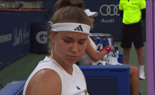 Woman in Adidas Headband on Bench at Audi Sign