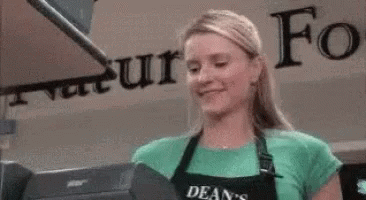 Woman in Apron at Cash Register