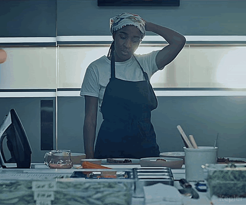 Woman in Apron at Counter With Kepler Sign