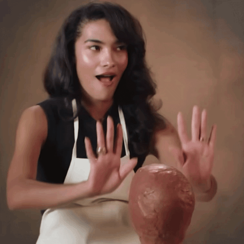 Woman In Apron Holding Head Statue GIF
