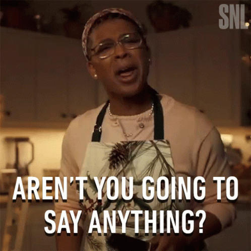 Woman in Apron Saying Aren't You Going To Say Anything