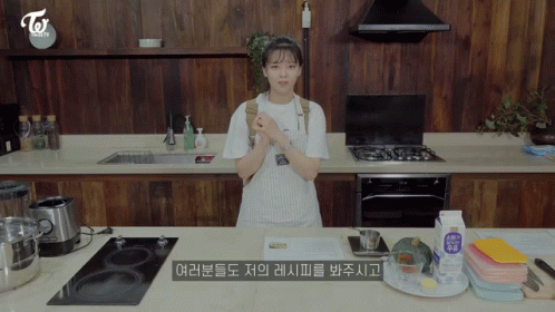 Woman in Apron Standing in Kitchen