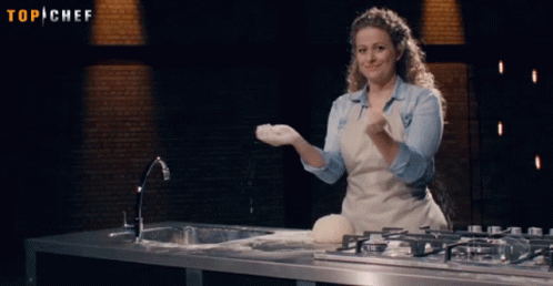 Woman In Apron Throwing Flour Under Top Chef Sign GIF