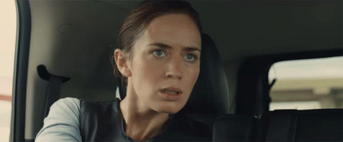 Woman in Back Seat of Car Looking at Camera