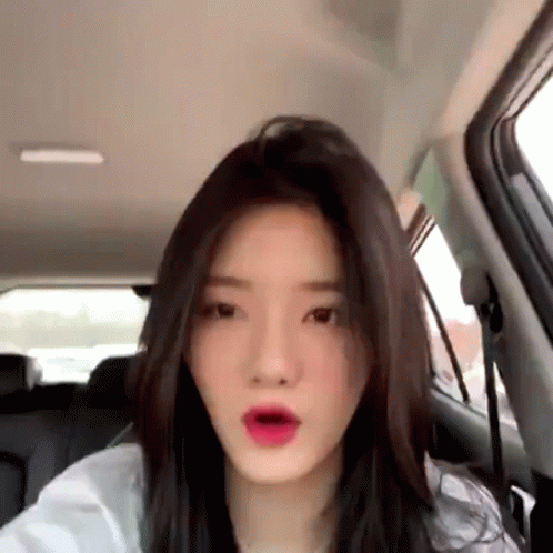 Woman In Back Seat Of Car Making Funny Face GIF