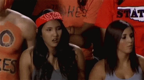 Woman in Bandana Next to Man in Hey State Shirt