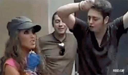 Woman in Baseball Cap Talking to Two Men