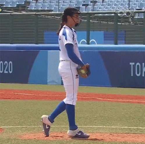 Woman In Baseball Uniform Walking On Field GIF