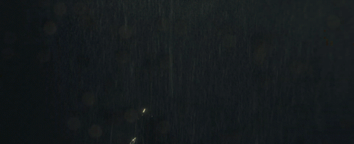 Woman in Bat Suit Standing in Rain