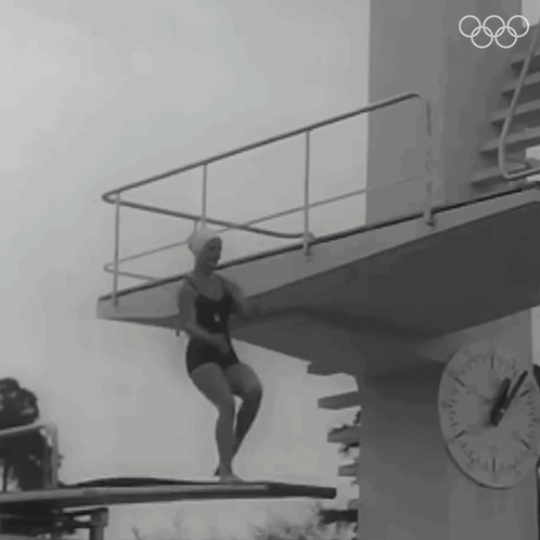 Woman in Bathing Suit on Diving Board