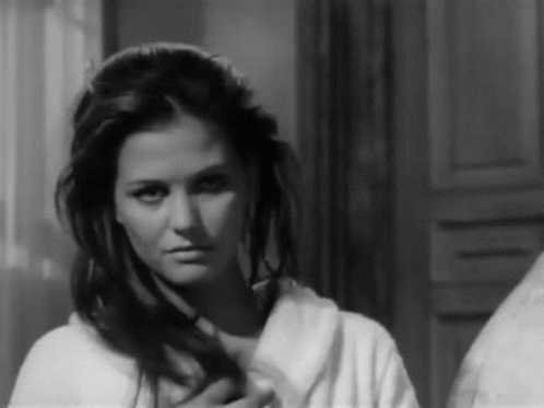 Woman in Bathrobe Looking in Mirror