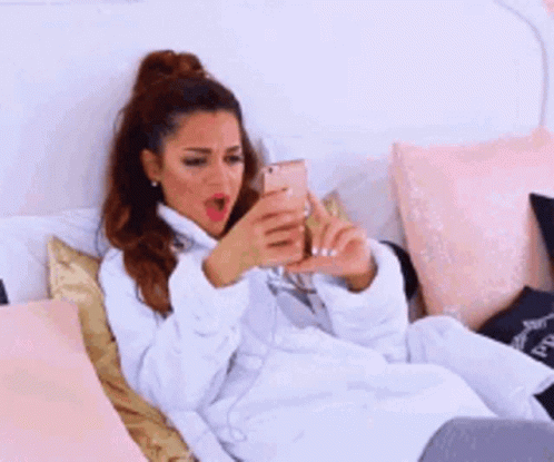 Woman In Bathrobe Lying On Bed GIF