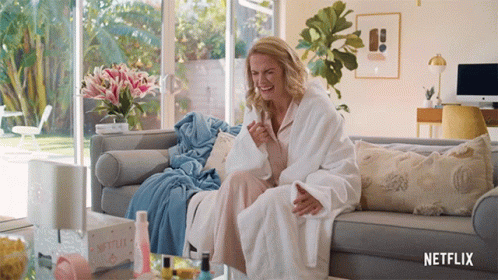 Woman in Bathrobe Sitting on Couch Netflix