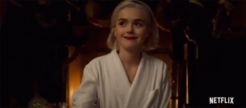 Woman in Bathrobe Smiling Holding Glass Netflix