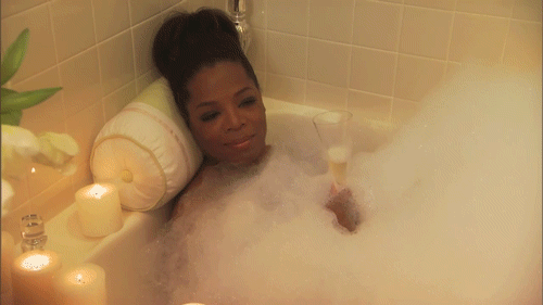 Woman in Bathtub With Glass of Wine