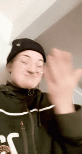 Woman in Beanie and Glasses Clapping
