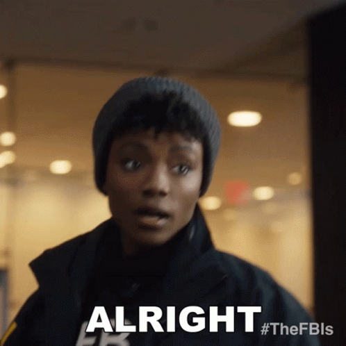 Woman in Beanie and Jacket Saying Alright