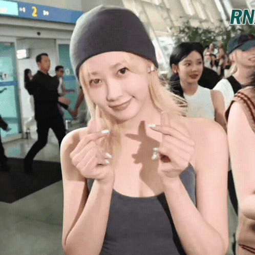 Woman in Beanie Making Heart Shape Saying RN