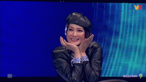 Woman in Beret and Headphones Smiling on TV