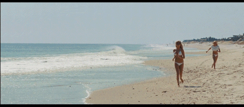 Woman in Bikini and Sunglasses on Beach