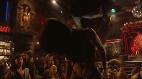 Woman in Bikini Dancing on Stage at Club