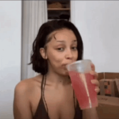 Woman in Bikini Drinking Red Drink From Cup