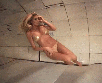 Woman in Bikini Floating in Room with 95