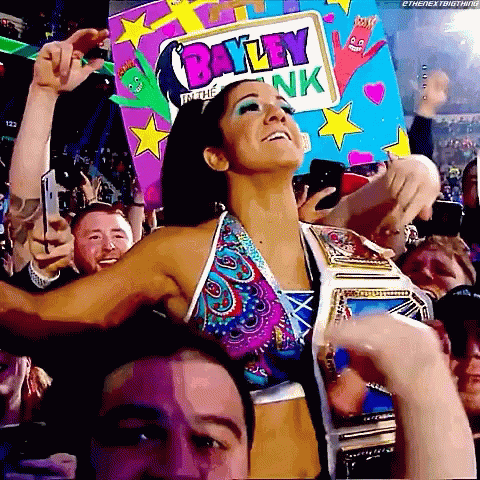 Woman in Bikini Holding Bayley in the Bank Sign