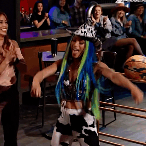 Woman in Bikini Holding Trophy in Wrestling Ring