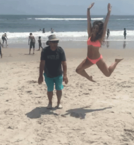 Woman in Bikini Jumping on Beach