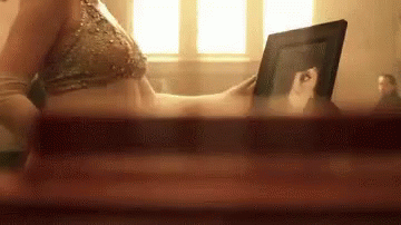 Woman in Bikini Looking at Picture of Herself