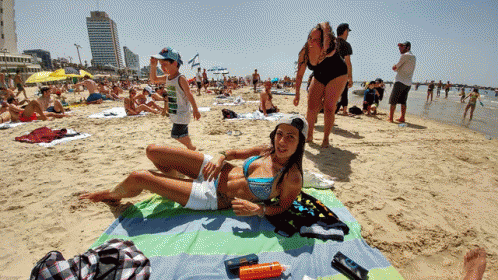 Woman in Bikini Lying on Beach Towel