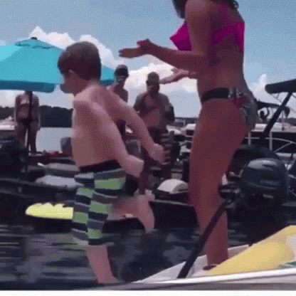 Woman In Bikini Next To Boy On Boat GIF