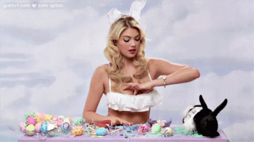 Woman in Bikini Sitting with Easter Eggs and Bunny