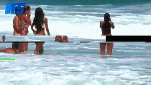 Woman In Bikini Taking Photo Of Another In Water GIF