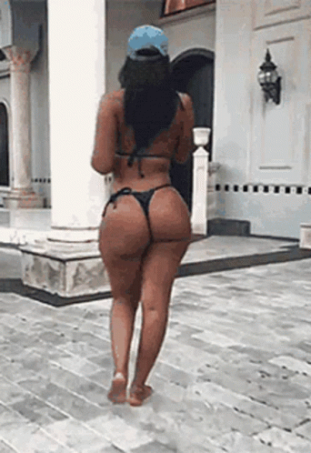 Woman In Bikini Walking On Brick Sidewalk GIF