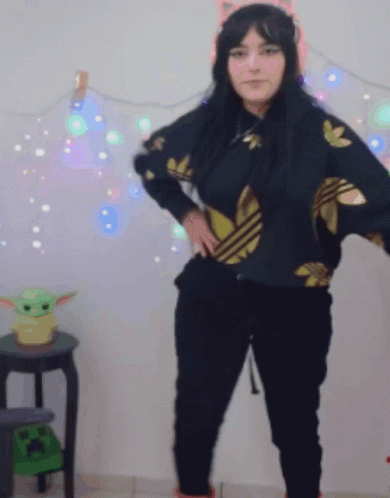 Woman in Black Adidas Near Green Baby Yoda