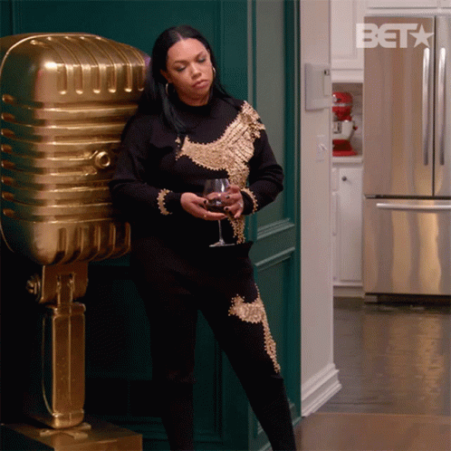 Woman In Black And Gold Holding Wine GIF