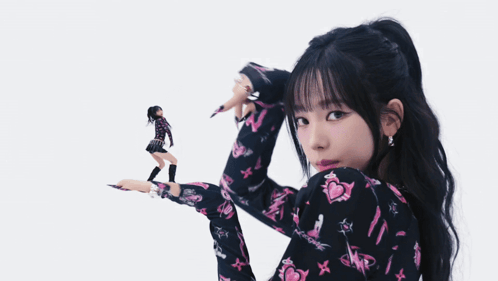 Woman in Black and Pink Floral Shirt Holding Doll