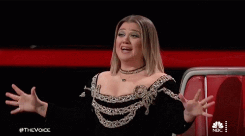 Woman in Black and Silver Dress With Hands in Air