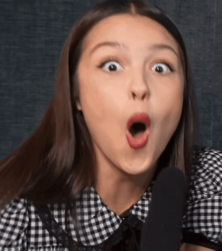Woman in Black and White Checkered Shirt Surprised