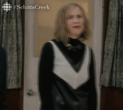 Woman in Black and White Dress at Schitt's Creek Door