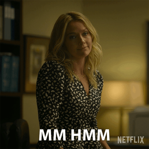 Woman in Black and White Dress Says Mmhmm Netflix Advertisement